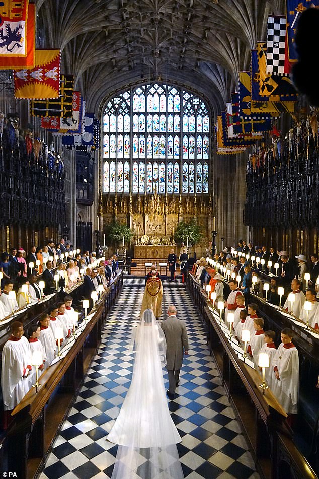 Charles is pictured walking Meghan, a divorcee and former actress, to the altar on her wedding day