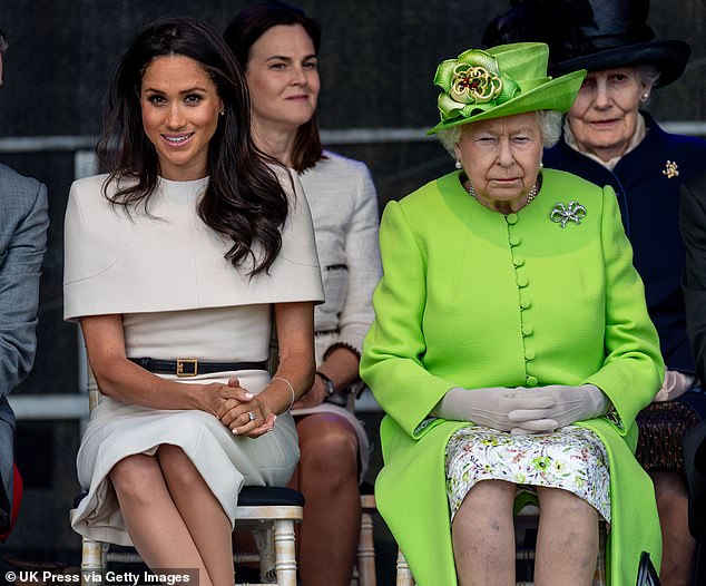 The Duchess of Sussex sits with the Queen during a visit in Widnes on June 14, 2018