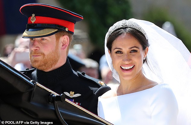 Prince Harry and Meghan ride back to Windsor Castle in their open-top carriage