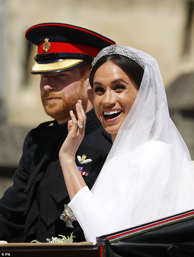 Meghan waves to the crowds gathered to see the newlyweds