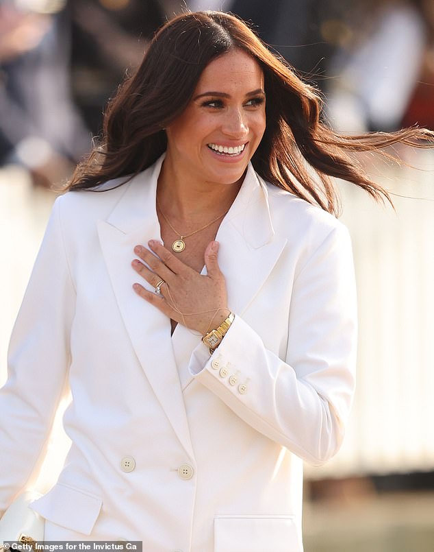 Her royal ring stack comprises her engagement ring from Prince Harry that's worth £126,000 ($150,000), wedding band worth around £9,550 ($12,700), and £75,000 eternity ring
