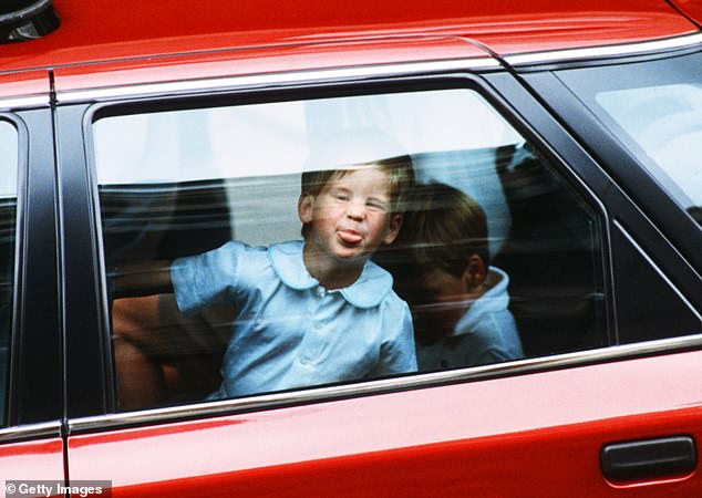 A young Prince Harry sticks his tongue out to the cameras