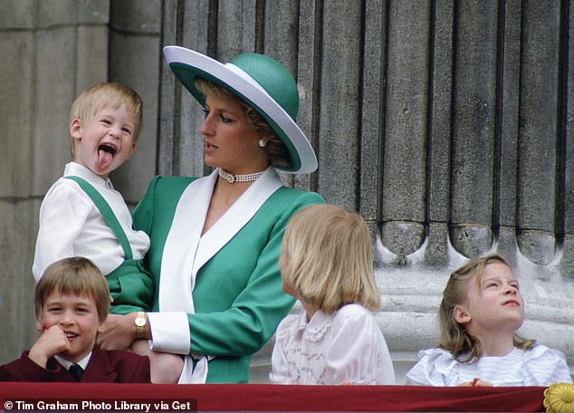 Prince Harry sticks his tongue out while being held by his mother, Princess Diana in 1988
