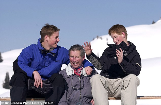 Prince William and Prince Harry share a joke with Prince Charles during a photocall on the ski slopes in Klosters, Switzerland
