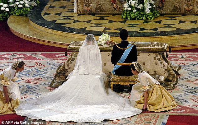 Created by Spanish designer Manuel Pertegaz, Letizia's gown features a structured silhouette elevated by a stand up collar and dramatic 15-foot train