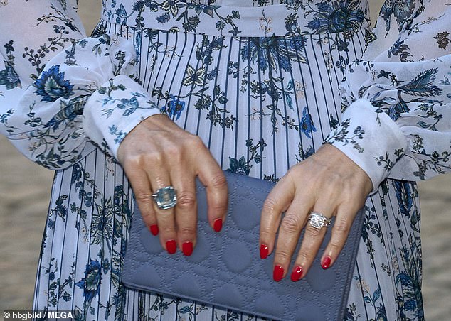 Queen Mary, 53, accesorised her Erdem dress and Lady Dior clutch with her matching oversized aquamarine statement ring, which she has had for many years