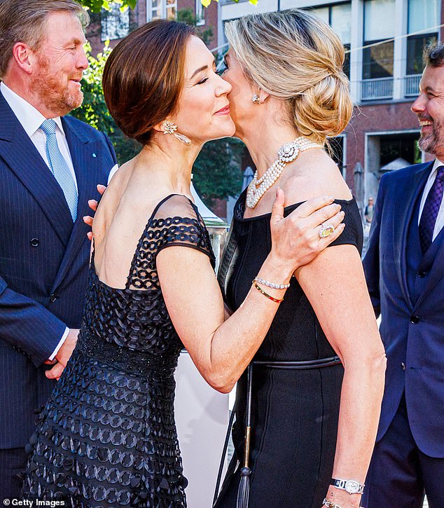 A large yellow cocktail ring was seen on full display as Queen Mary greeted Queen Maxima of the Netherlands at a June 2022 gala dinner