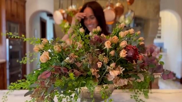 Meghan assembles the roses and various greenery into a beautiful floral arrangement