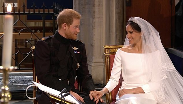 On their special day Harry and Meghan held hands as they sat close to Bishop Curry and listened intently