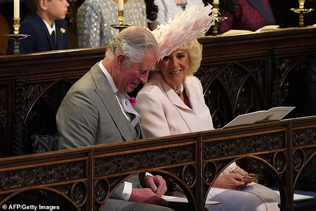 Charles, sat at the wedding with wife Camilla, was red faced and lowered his head