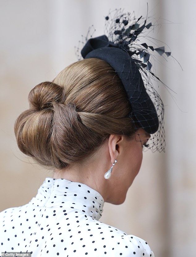 Kate styled her sleek brunette tresses in an intricate up-do for the occasion, perfectly showcasing her black fascinator