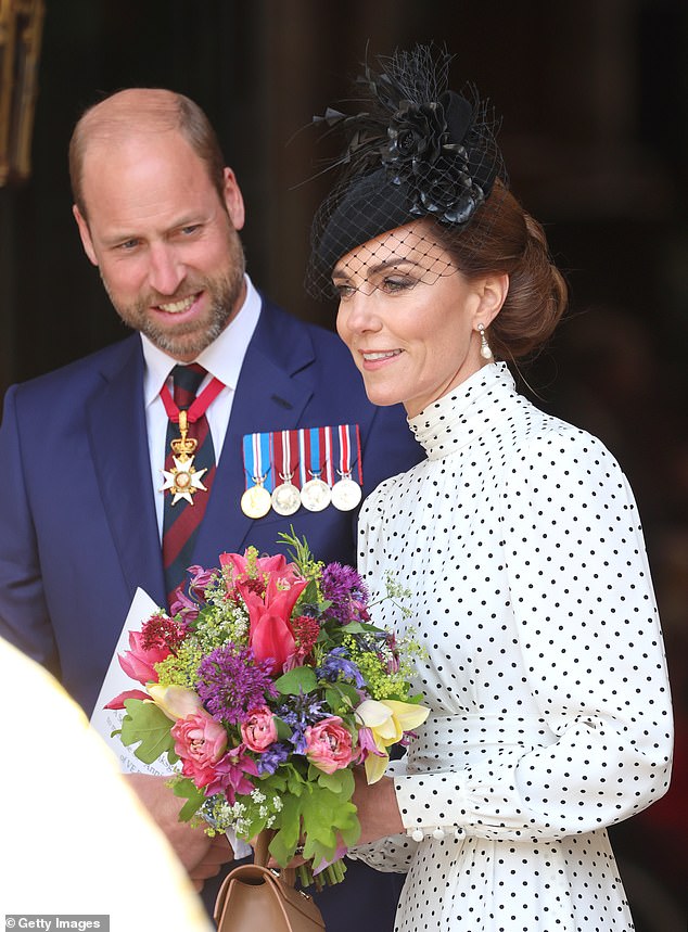 William adoringly looked on as his wife Kate carried the floral tribute