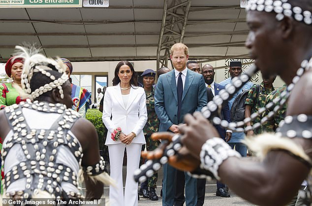 Harry and Meghan are pictured on arrival in Nigeria as crowds gathered to greet them and the military rolled out the red carpet