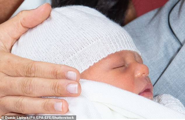 Meghan, Duchess of Sussex, places her hand next to her baby son Archie Harrison Mountbatten-Windsor at the photocall to celebrate his birth at Windsor Castle
