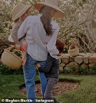 Meghan is pictured with Archie and Lilibet in her garden