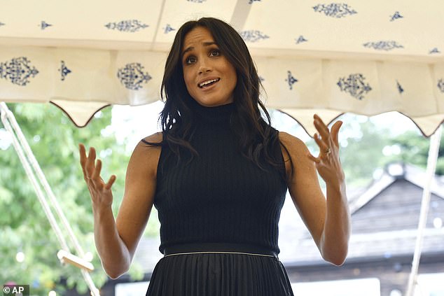 Meghan welcomes women involved with the cookbook Together during a reception at Kensington Palace