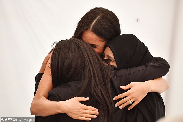 Many people believe helping to create the cookbook was one of Meghan's best actions as a working royal. Meghan is pictured hugging women at the launch