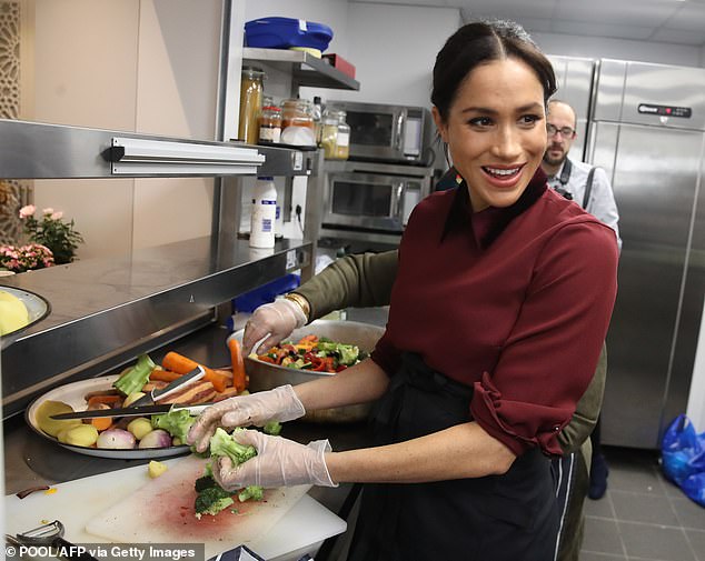 Meghan helps out in the kitchen set up by women affected by the Grenfell Tower fire