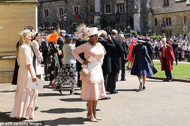Oprah leaving the wedding ceremony. According to author Tina Brown, the star had 'scarcely met' Meghan before the big day