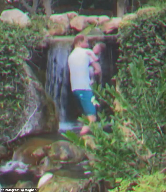 In one adorable moment, father-of-two Harry playfully dipped his son Archie towards a stunning waterfall