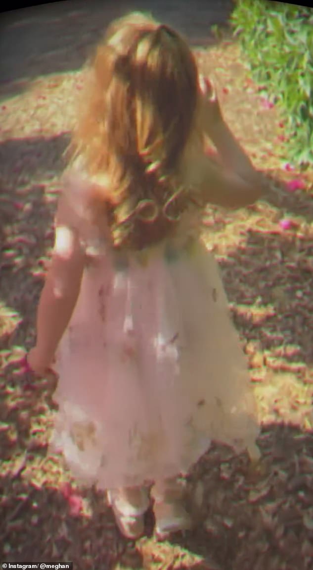 Lilibet looked adorable in a pink, flowing dress while walking outside and eating an apple with her mother