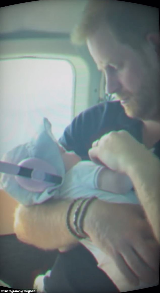 In another sweet moment, Lilbiet donned pink protective headphones as she slept in her father's hands