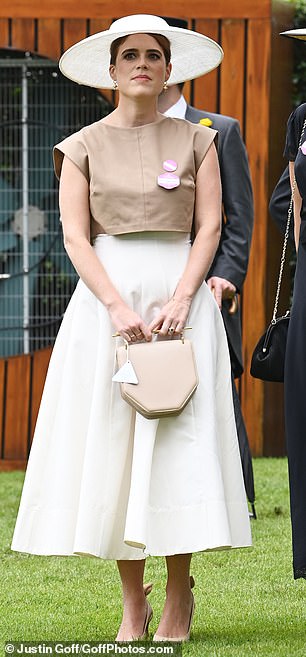 Putting on a chic display, Eugenie stunned in a stylish wide-brimmed hat and flattering dress featuring a billowing white skirt and a square-shouldered brown top