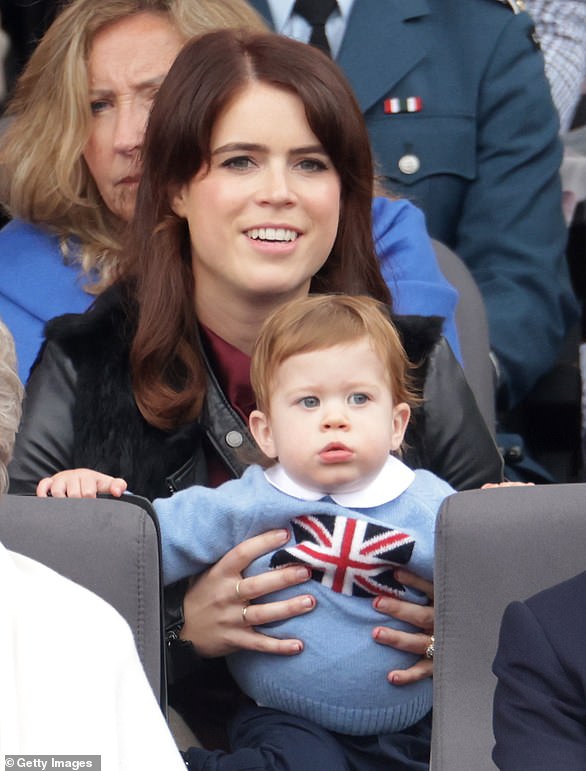 Eugenie holds her son August Brooksbank while watching the Platinum Jubilee Pageant from the Royal Box on June 5, 2022